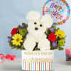 White flower dog arrangement with a birthday balloon in a decorated container