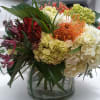 large low cylinder filled with white and miniature green hydrangeas, sunset orange