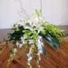A tranquil and stylish casket spray will adorn the top of your