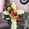 White Poms fill the cross with a banner of assorted blooms