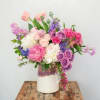 Mixture of colorful flowers in ceramic containers 