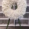 Large wreath of all white hydrangeas and roses.