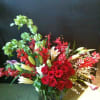Lovely array of roses, lilies, belles of ireland, orchids and other season