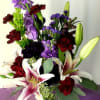 This is a majestic arrangement made with shades of purple and red