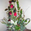 1/2 dozen roses and lilies arranged with high style and elegant ambiance.