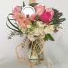 Soft, pink pastel flowers nestled in a glass Mason jar....an all time