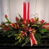  With ribbons, fresh pine, and candles, this design will bless the
