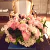 Exquisite low centerpiece feutering primium flowers and delicate colors such as pink