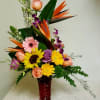Tropical bouquet of birds of paradise, roses, orchids, sunflowers and gerbera.