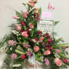 The freshest pink roses and seasonal accent flowers in a tin container