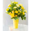 Yellow roses, carnations, solidago, and moms in a tall yellow vase