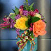 Different Color Roses, Alstro, Waxflower and more in this magical arrangement!
