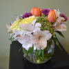 Tulips, Alstro, roses and more in this low but astonishing arrangement!