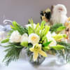 A beautiful round  bouquet filled with lilies and white roses and