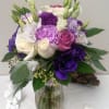 Lavender and purple medley of lisianthus, roses, carnations, hydrangea with seeded eucalyptus.