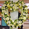 Beautiful assortment of white flowers including white Cymbidium orchids, Roses and other