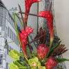 Tropical flowers arranged in a low black container