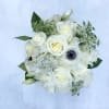 This lush arrangement will be made up of white and green seasonal