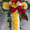 Medium cross with roses, pom pom, larkspur, tropical leafs, spider flowers, and