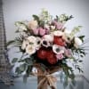 Elegant organic Bouquet in cylinder vase dressed with burlap
