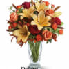 Roses, lilies and leaves create a fantasy of fall flowers. Send this
