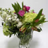 A beautiful crystal vase filled with tulips, stock and hydrangea