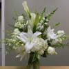 Vase of all white calla lilys, white oriental lilys with white orchids
