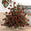 Stunning presentation of red roses filling a large floral urn and representing