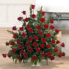 Stunning presentation of red roses filling a large floral urn and representing