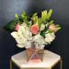 A soft pastel arrangement filled with hydrangeas and lilies. At times you