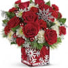 
Deck the halls with this festive arrangement of rich red roses, winter