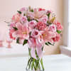 Filled with a delicate mix of roses, lilies and carnations in various