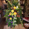 Spray on a stand with a variety of flowers placed in a