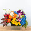 A burst of color welcomes you in this design. Roses, ranuncula, calla