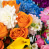 A burst of color welcomes you in this design. Roses, ranuncula, calla