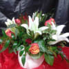 White lilies, spray roses &amp; reg. roses with a mixture of greens