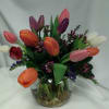 Tulips with some filler flowers and greens in a bubble bowl. Colors