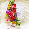 Pink roses, mini red carnations, purple statice, viking pom yellow.