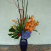 Blue vase with peachy and orange flowers 