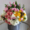 This Chocolato arrangement is made with yellow and pink roses, hypericum berries