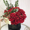 This Chocolato arrangement is made with red roses, spray roses, myrtle, curly