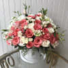 This Chocolato arrangement is made with white and pink roses, spray roses