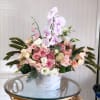 This Chocolato arrangement is made with phalaenopsis orchids, pink roses, spray roses