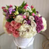 This Chocolato arrangement is made with light and dark pink roses, spray