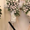 White Roses and Hydrangeas in a cross shape with greens.

Please put name