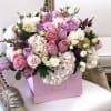 This Chocolato arrangement is made with purple and pink roses, spray roses