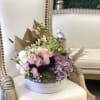 This Chocolato arrangement is made with Roses, Succulent, Orchid and Berries. The