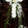 All white Celebration of Life cross. China, Lilies, Roses, Orchid. This is