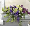 Lavender, purples, and green In casket spray
