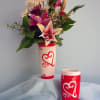 Lilies, Roses and Daisies. Vase will vary.